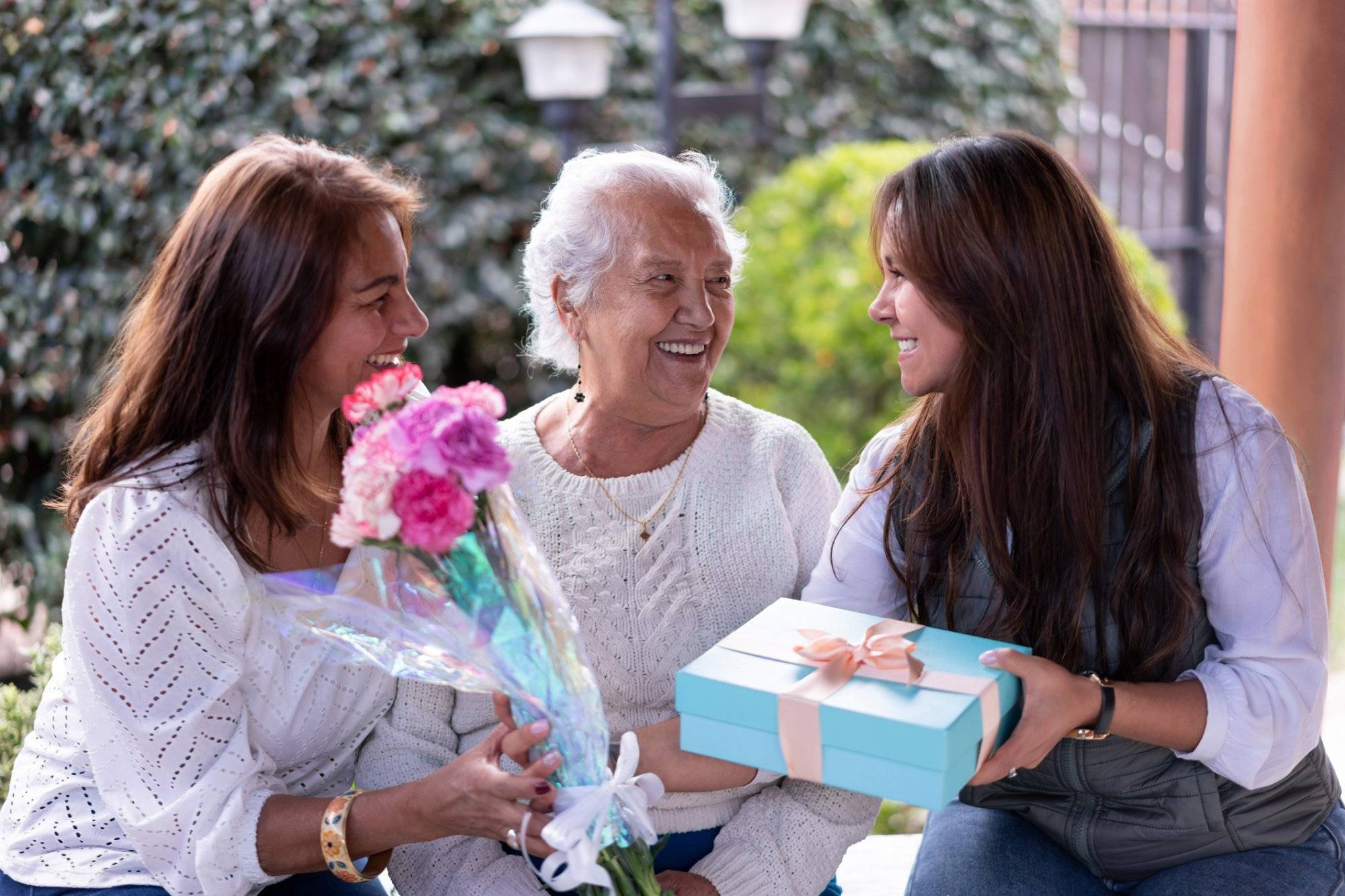 Three generations portrait celebrating motherâs day all smiling very happy