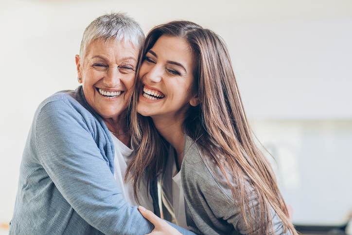 Happy adult mother and daughter embracing